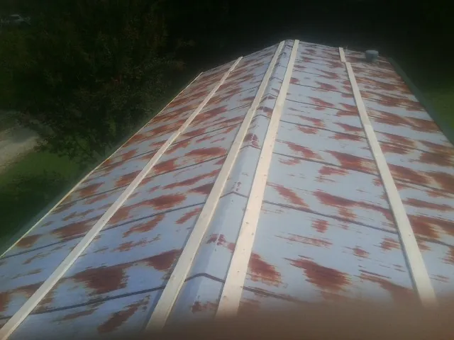Rusted metal roof panels with new wood purlins before replacement — Storm Damage Roof Repair in Foosland by Roofing Brothers