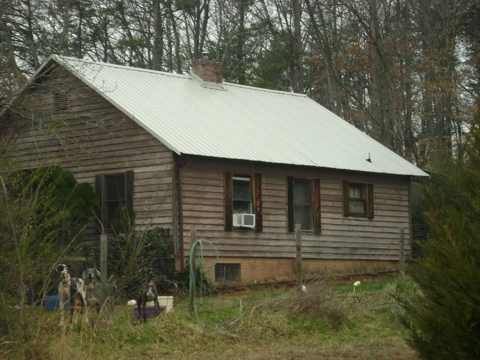White metal roof on an old wood sided farmhouse, from a Metal Roof Installation job in Foosland